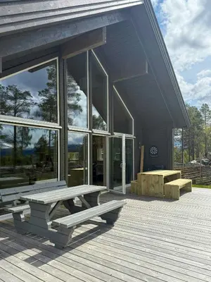 a building with a picnic bench on a deck at Modern Cabin For Large Families In Oppdal in Oppdal