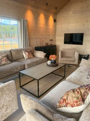 a living room with a couch and a coffee table at Modern Cabin For Large Families In Oppdal in Oppdal