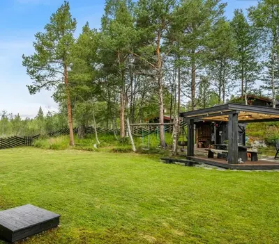 a pavilion in the middle of a grass field at Family-Friendly Cabin With Zipline Near Oppdal in Rennebu
