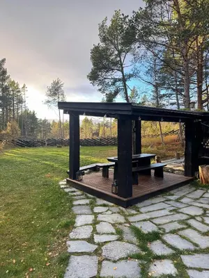 a picnic shelter with a picnic table in a park at Family-Friendly Cabin With Zipline Near Oppdal in Rennebu