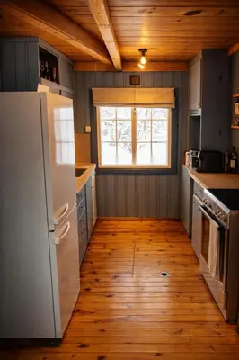 a kitchen with a white refrigerator and a window at 6 Bed traditional mountain cabin in Geilo - close to skiing and hiking in Hol