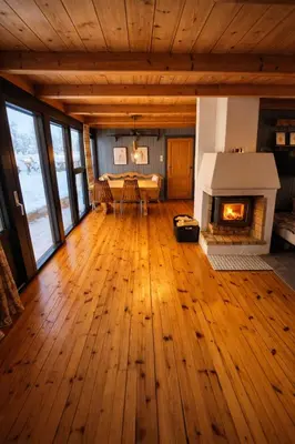 a living room with a wood floor and a fireplace at 6 Bed traditional mountain cabin in Geilo - close to skiing and hiking in Hol