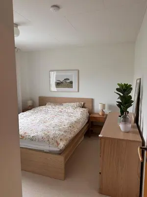 a bedroom with a bed and a table with a potted plant at Perfect family house in Voss in Vossevangen