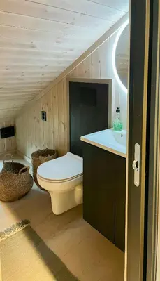 a bathroom with a toilet and a sink at Cabin At Groholsfjellet For Active Days in Veggli