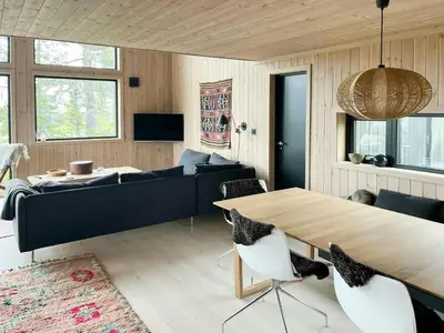 a living room with a couch and a table at Cabin At Groholsfjellet For Active Days in Veggli