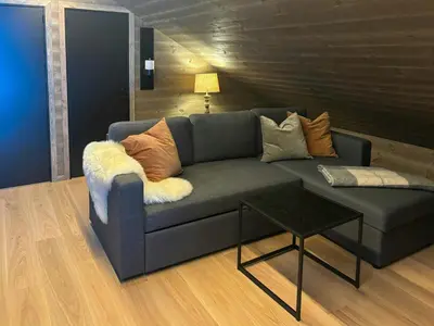 a living room with a couch and a table at Cabin With Ski-Inski-Out At Stranda Ski Resort in Stranda