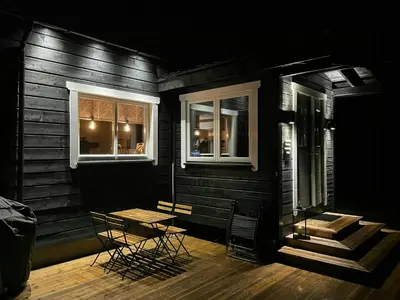 a stage with two chairs and a table and two windows at Renovated Cabin On The West Side Of Trysil in Trysil