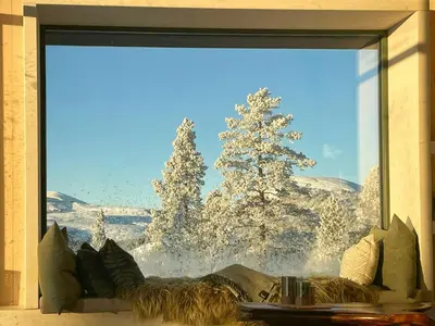 a window with a view of a snow covered tree at Eco-Friendly Cabin With Panoramic Views In Savalen in Tynset