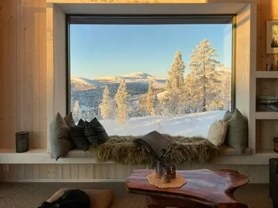 a window with a view of a snowy mountain at Eco-Friendly Cabin With Panoramic Views In Savalen in Tynset