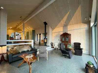 a living room with a couch and chairs and a table at Eco-Friendly Cabin With Panoramic Views In Savalen in Tynset