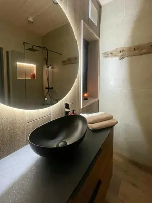 a bathroom with a black sink and a mirror at Eco-Friendly Cabin With Panoramic Views In Savalen in Tynset