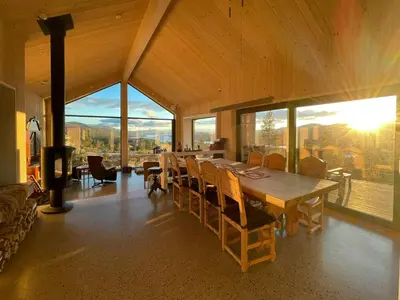 a dining room with a large wooden table and chairs at Eco-Friendly Cabin With Panoramic Views In Savalen in Tynset
