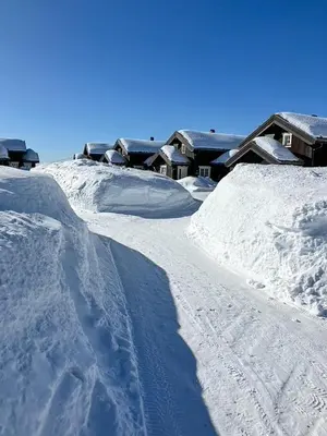 a snow covered slope with houses in the background at Cabin Near Ski Trails In Tempelseter in Eggedal