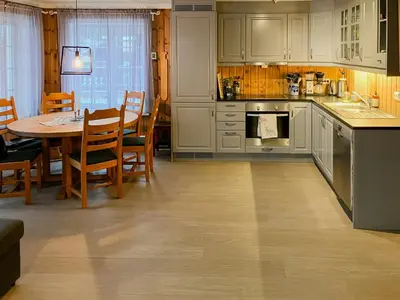 a kitchen with a table and a dining room at Cabin Near Ski Trails In Tempelseter in Eggedal