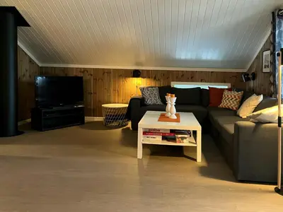 a living room with a couch and a tv at Cabin Near Ski Trails In Tempelseter in Eggedal