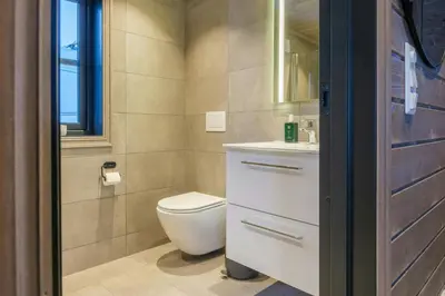 a bathroom with a toilet and a sink at Modern Cabin With Ski-Inski-Out At Hafjell in Øyer