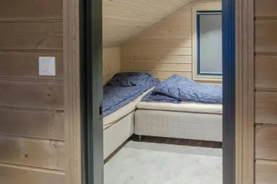 a small bed in a small room in a tiny house at Modern Cabin With Ski-Inski-Out At Hafjell in Øyer