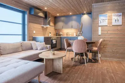 a living room with a couch and a table at Modern Cabin With Ski-Inski-Out At Hafjell in Øyer
