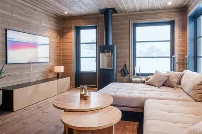 a living room with a couch and a table at Modern Cabin With Ski-Inski-Out At Hafjell in Øyer