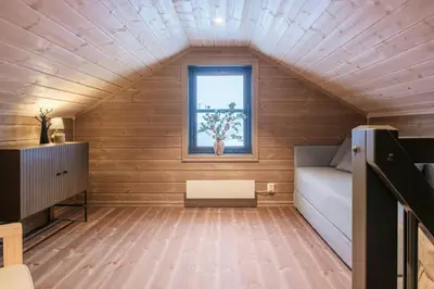 a small room with a couch and a window at Modern Cabin With Ski-Inski-Out At Hafjell in Øyer