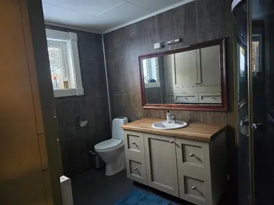 a bathroom with a sink and a toilet and a mirror at Fjellro appartment in Os