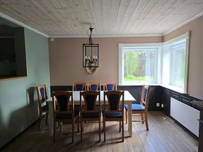 a dining room with a table and chairs at Fjellro appartment in Os