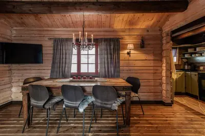 a dining room with a wooden table and chairs at Charming cabin by Hallingskarvet ski center in Hol
