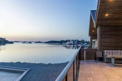 a view of the water from the deck of a house at Fisherman's Cottage With Sea Views At Kalvaneset in Steinvik