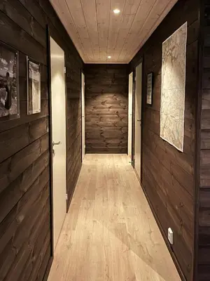 a hallway with wood paneled walls and a long corridor at Moderne Og Koselig Hytte På Hardangervidda in Garden