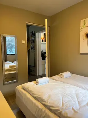 a bedroom with two beds and a mirror at Prime Location - Cozy and Big House in Vossevangen