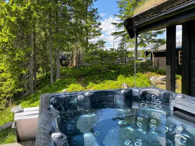 a hot tub in the backyard of a house at Family Cabin With Hot Tub At Skeikampen in Svingvoll