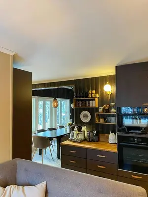 a kitchen with a couch and a table in a room at Family Cabin With Hot Tub At Skeikampen in Svingvoll