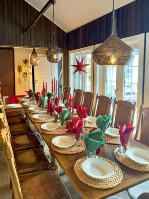 a long table with red candles and plates on it at Family Cabin With Hot Tub At Skeikampen in Svingvoll