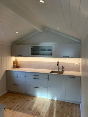 a kitchen with white cabinets and a sink at Olastova, et koselig lite hus i nær Stryn sentrum in Stryn