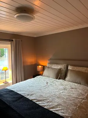 a bedroom with a large bed and a window at Olastova, et koselig lite hus i nær Stryn sentrum in Stryn