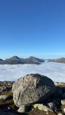 a large rock sitting on top of a body of water at Olastova, et koselig lite hus i nær Stryn sentrum in Stryn