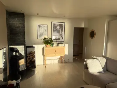 a living room with a couch and a table at Modern and central apartment with a view in Ålesund