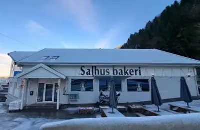 a salmis bakery with umbrellas in front of it at Salhusvegen in Bergen