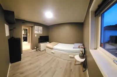 a small bedroom with a bed and a window at Fjordclaw SNM- Cozy & Premium Feel in Bergen