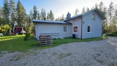 a small blue house on a gravel yard at Grandma Guest House, Rena Near Ski, Biking, River summer camp in Åmot