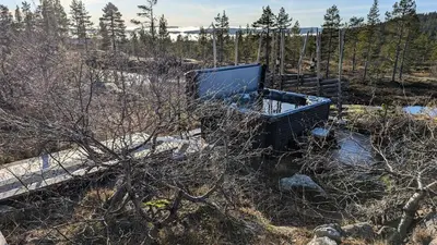 a tv sitting in the middle of a field at Fjellhytte med boblebad og utsikt på Blefjell in Flesberg