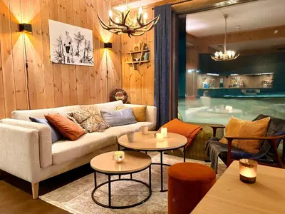 a living room with a couch and two tables at Elegant 2 bedroom ski in, ski out apartment next to Fyri Resort in Hemsedal in Hemsedal