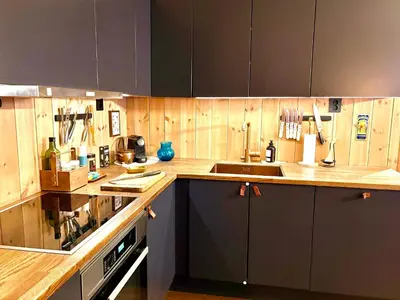 a kitchen with wooden cabinets and a sink at Elegant 2 bedroom ski in, ski out apartment next to Fyri Resort in Hemsedal in Hemsedal