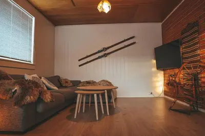 a living room with a couch and a table at Close to cross-country skiing, slalom slope and mountains - Soltun Geilo in Hol