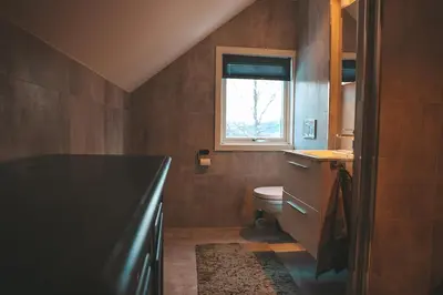 a bathroom with a toilet and a window at Close to cross-country skiing, slalom slope and mountains - Soltun Geilo in Hol