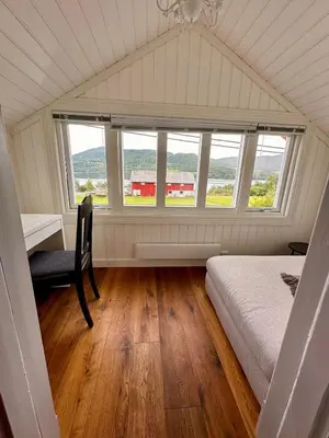 a bedroom with a bed and a desk and a window at Winter paradise Norefjell in Surteberg
