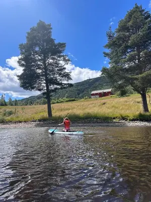 a person in a kayak in the water at Winter paradise Norefjell in Surteberg