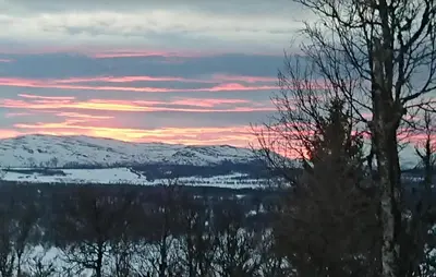 a view of a snow covered mountain with a sunset at Gorgeous Home In Gålå With House A Mountain View in Gålå