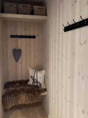 a wooden wall with a shelf with a pair of glasses on it at Cabin At The Gateway To Jotunheimen in Tessand