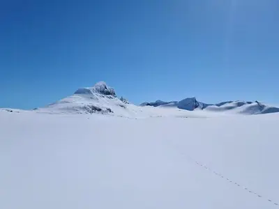 a snow covered mountain in front of a blue sky at Cabin At The Gateway To Jotunheimen in Tessand